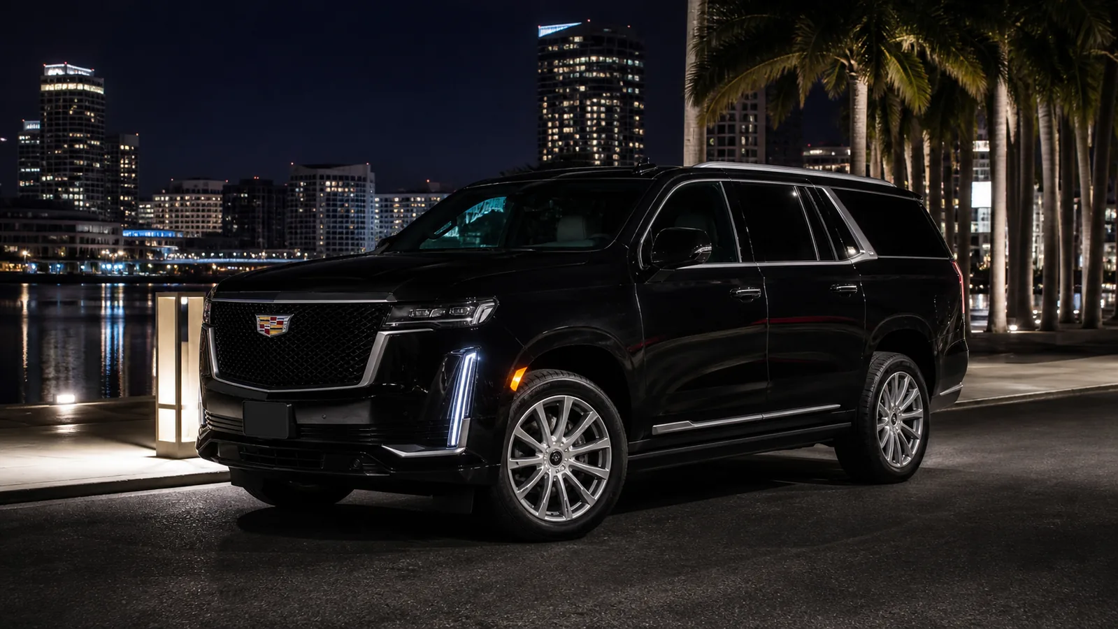 Black 2022 Cadillac Escalade in an upscale Miami waterfront setting at night